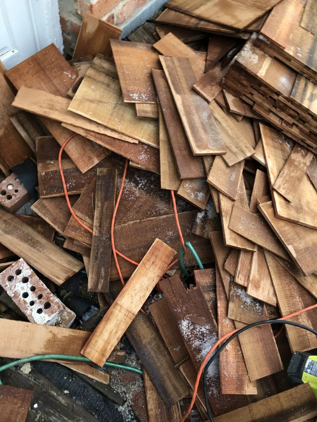 Old cedar shakes stripped and piled for same-day haul-away