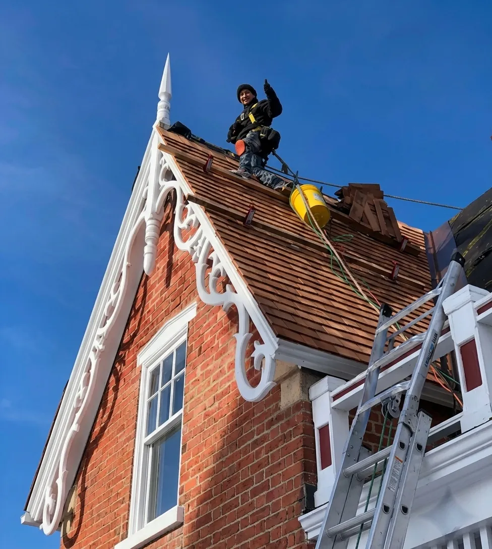 Exelu crew member standing confidently on a roof job in daylight