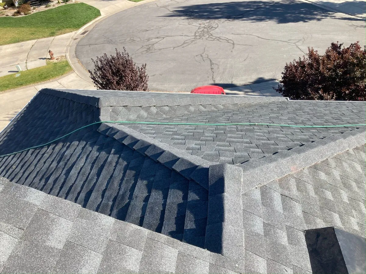 Finished shingle ridge line above a quiet cul-de-sac