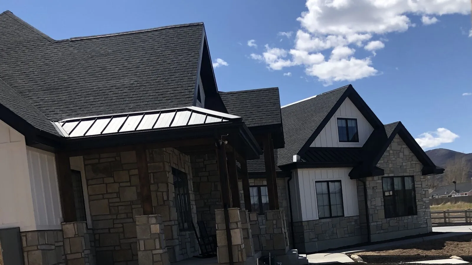 Residential exterior and roofline photographed from the street during project review